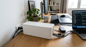 Best cable boxes for a home office — white cable box hiding a power strip and cords on a desk