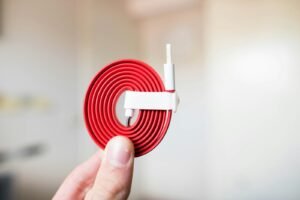 Best cable management clips for a home office — white clip holding a coiled charging cable
