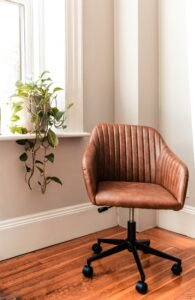 Rolling office chair beside a green plant in a home office